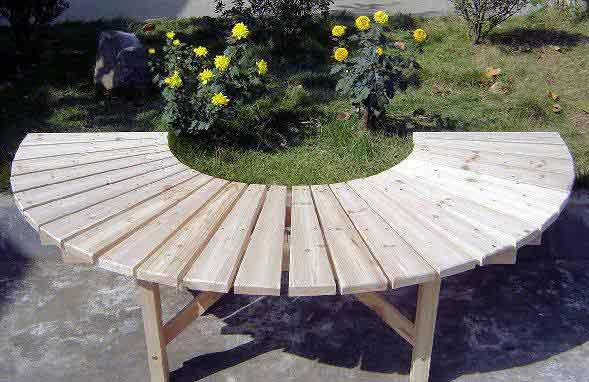 Full circular tree bench with no back support in a public park.